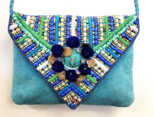 LEATHER SUEDE BOHEMIAN POM POM CLUTCH